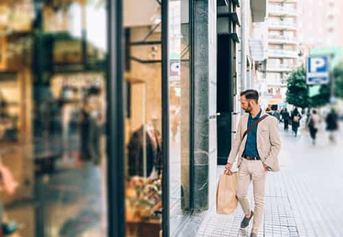 photo of a consumer looking into a retail show window